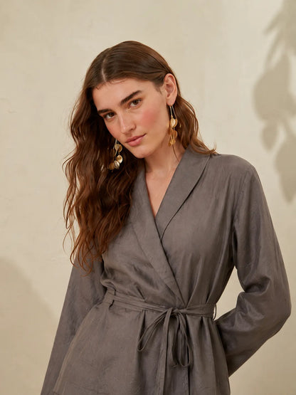 Grey wrap-style jumpsuit with long sleeves, V-neck, and drawstring waist tie