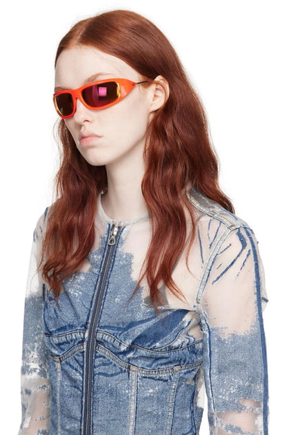 Red wrap sunglasses with orange tinted lenses on model