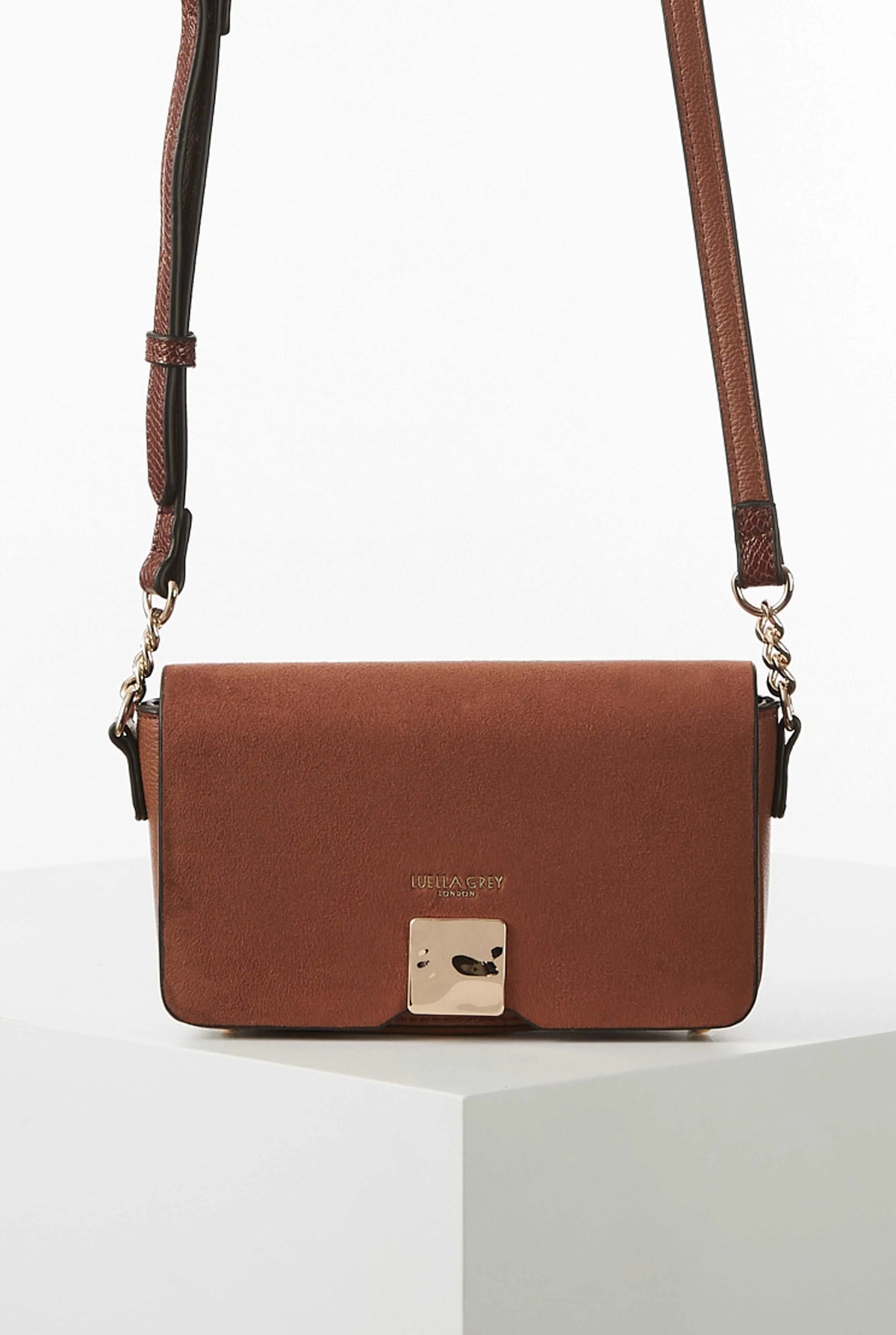Brown flap crossbody bag with gold-tone clasp and chain shoulder straps