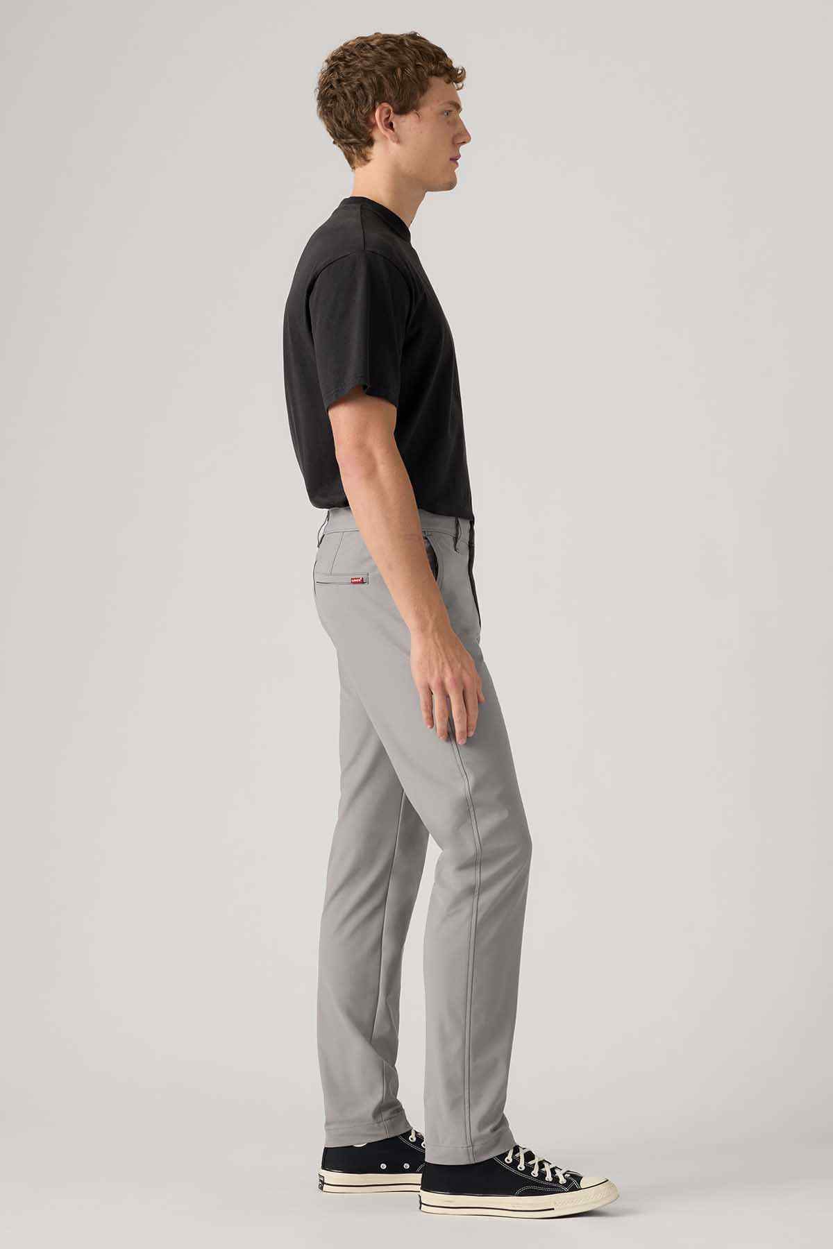 Men's grey jeans side view, slim-straight leg and button fly
