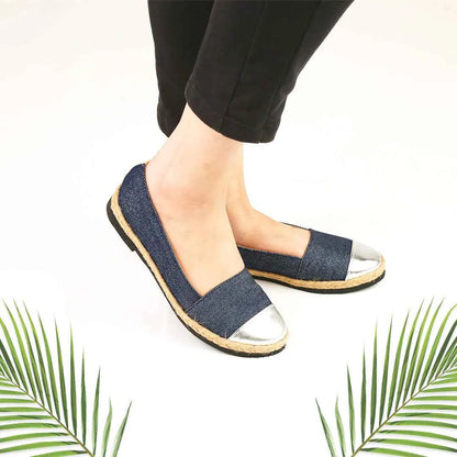 Blue denim slip-on flats with silver toe and tan rubber sole