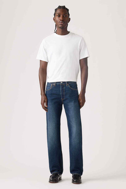 Dark wash denim jeans with straight legs, front button fly, and back pockets