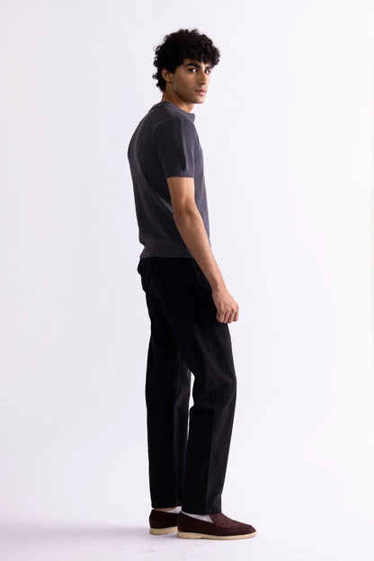Men's dark gray polo shirt, short sleeves and collar, side view with black trousers