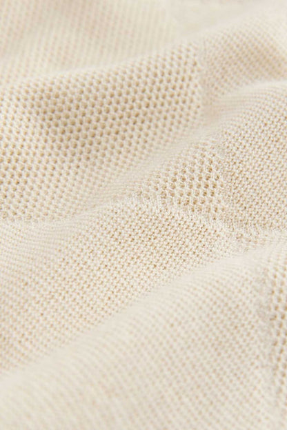 Cream woven fabric texture for NEXT polo shirt, close-up