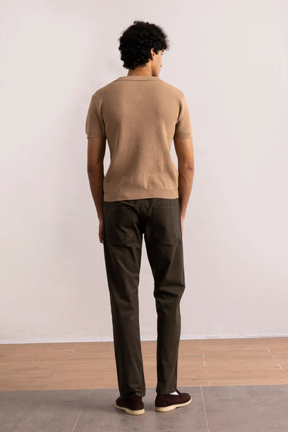 Brown knit polo shirt back view showing collar and short-sleeve fit