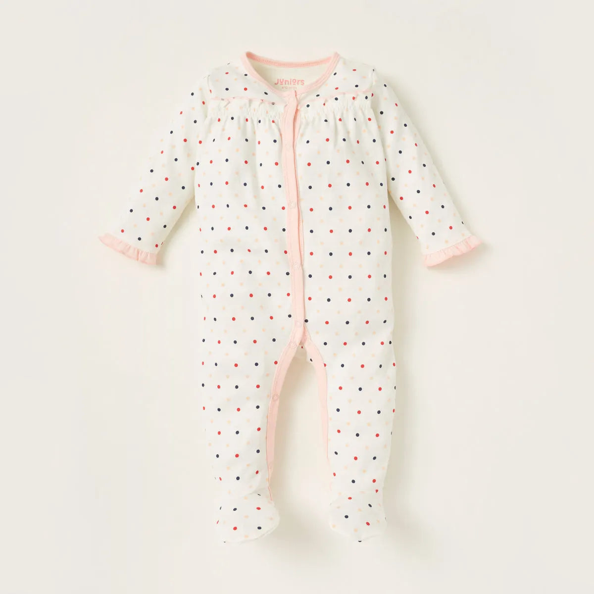 White baby footless romper with multicolor dot print and pink button placket