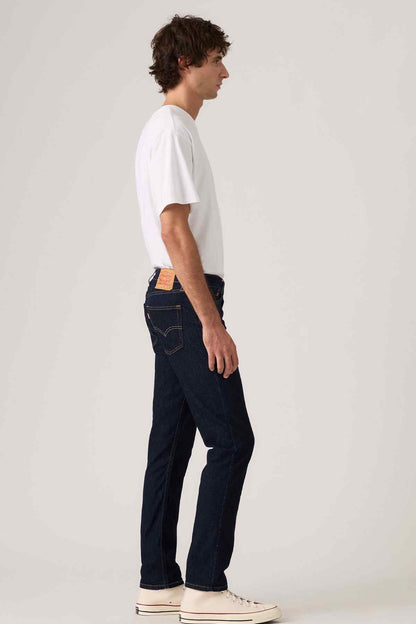 Dark blue denim jeans with contrast stitching and five-pocket design, side view