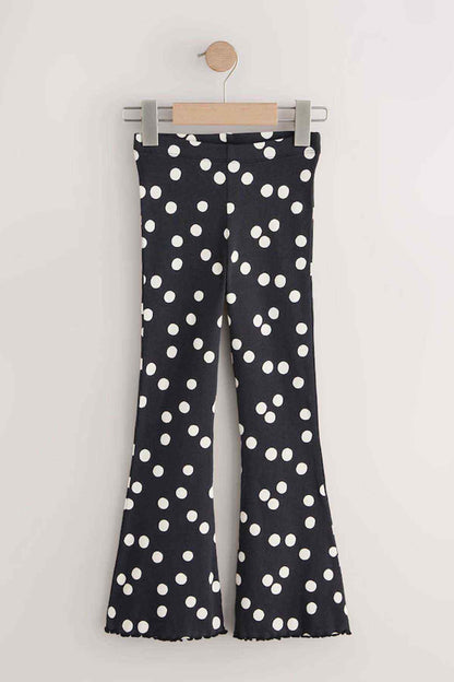 Kids black polka-dot flared pants on hanger