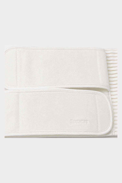 Cream belly support belt close-up of padded front panel and subtle logo