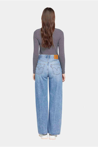 Levi's light-wash denim jeans, back view with wide-leg silhouette and belt loops.