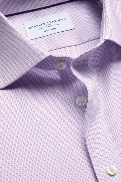 Purple dress shirt collar label and round buttons on textured fabric