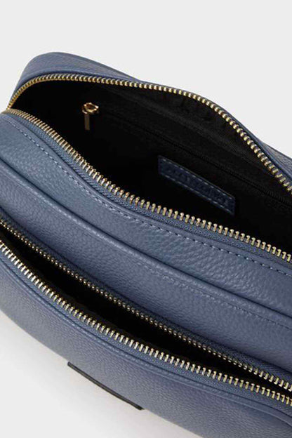 Blue textured crossbody bag with open zip interior and card slot pocket