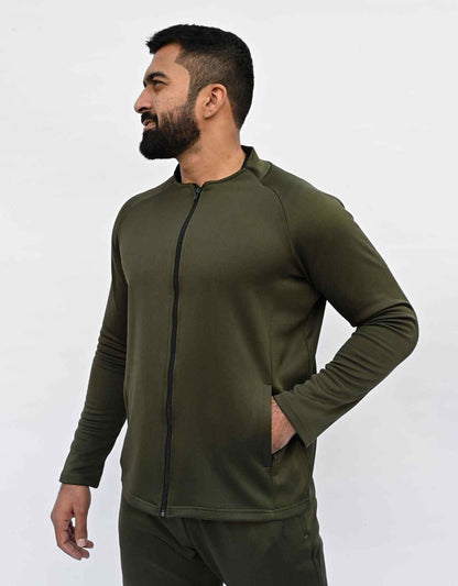 Bodybrics men's olive zip-up jacket and matching pants set, side profile with hand in pocket