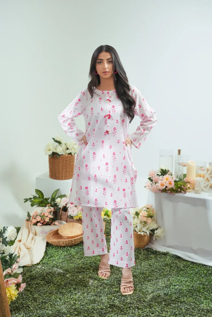 Women's white floral kurta and pajama set, standing full-length, pink floral pattern