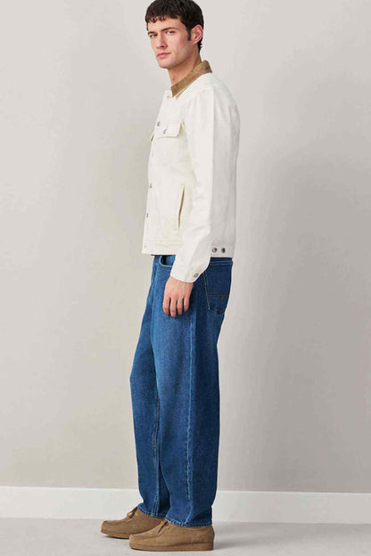Mid blue denim jeans, straight leg and button fly, side view