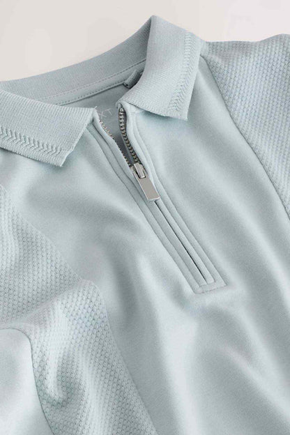 Light blue half-zip stand-collar shirt with textured fabric placket