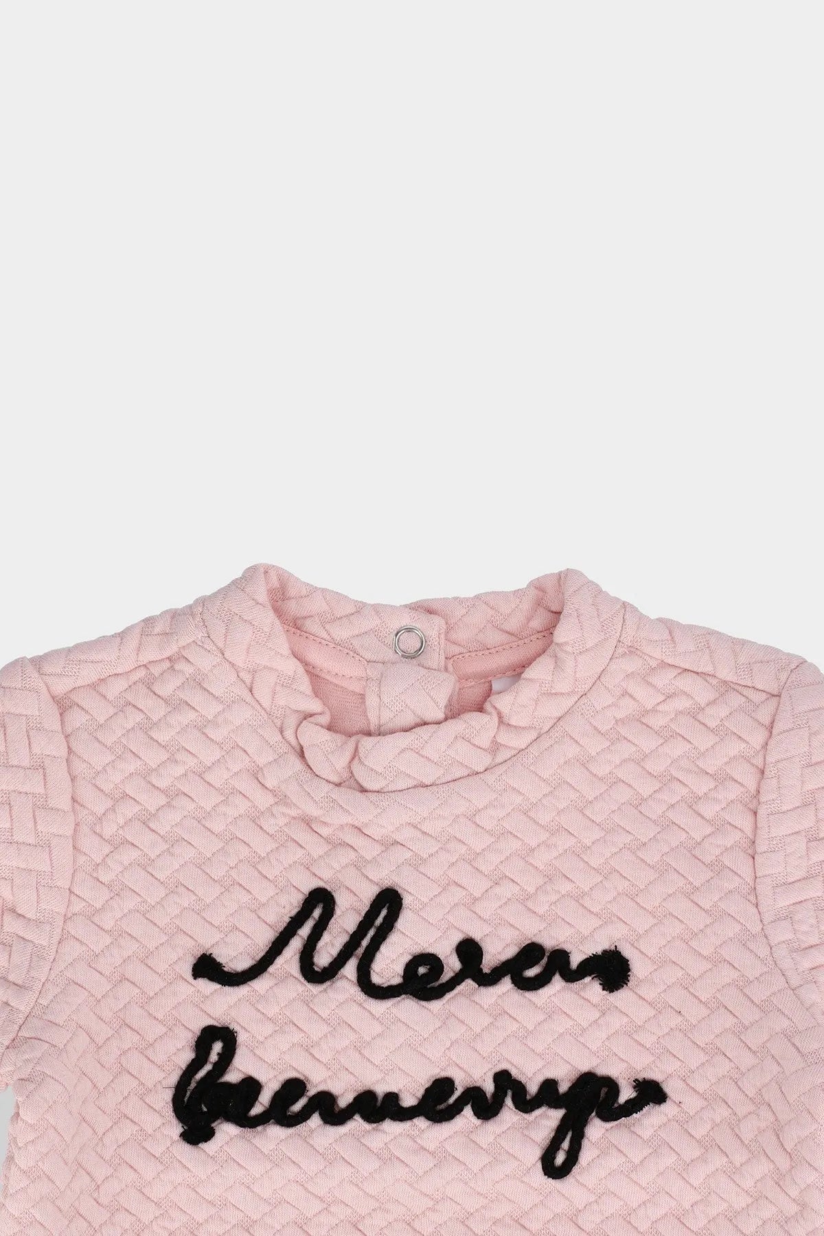 Pink textured baby top with black script front and buttoned round collar