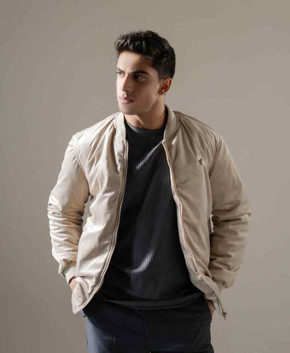 Men's beige bomber jacket with front zipper and ribbed cuffs; small chest logo