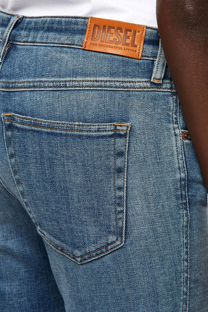 Light blue denim jeans with stitched back pocket and visible yoke seam