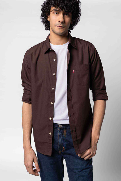 Levi's dark brown long-sleeve button-up shirt worn over a white tee