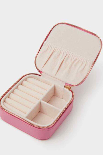 Pink zip jewelry case with open compartments and padded slots