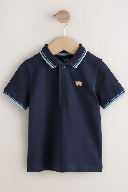 Navy polo shirt on wooden hanger with button placket and bear logo