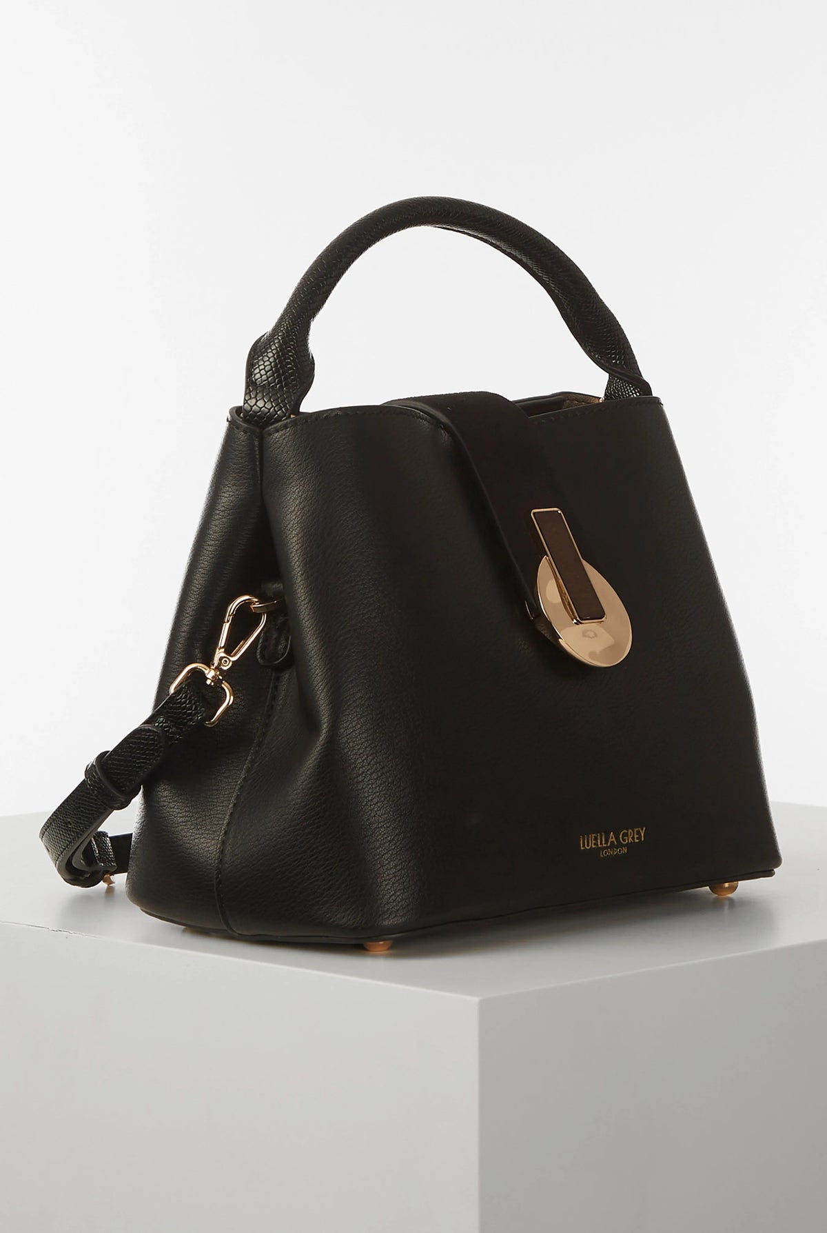 Black handbag with top handle, gold-tone front clasp and side D-ring strap detail