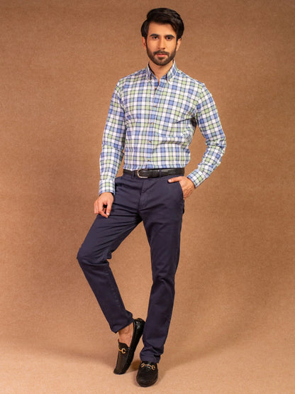 Men's plaid button-up shirt and navy trousers, full outfit