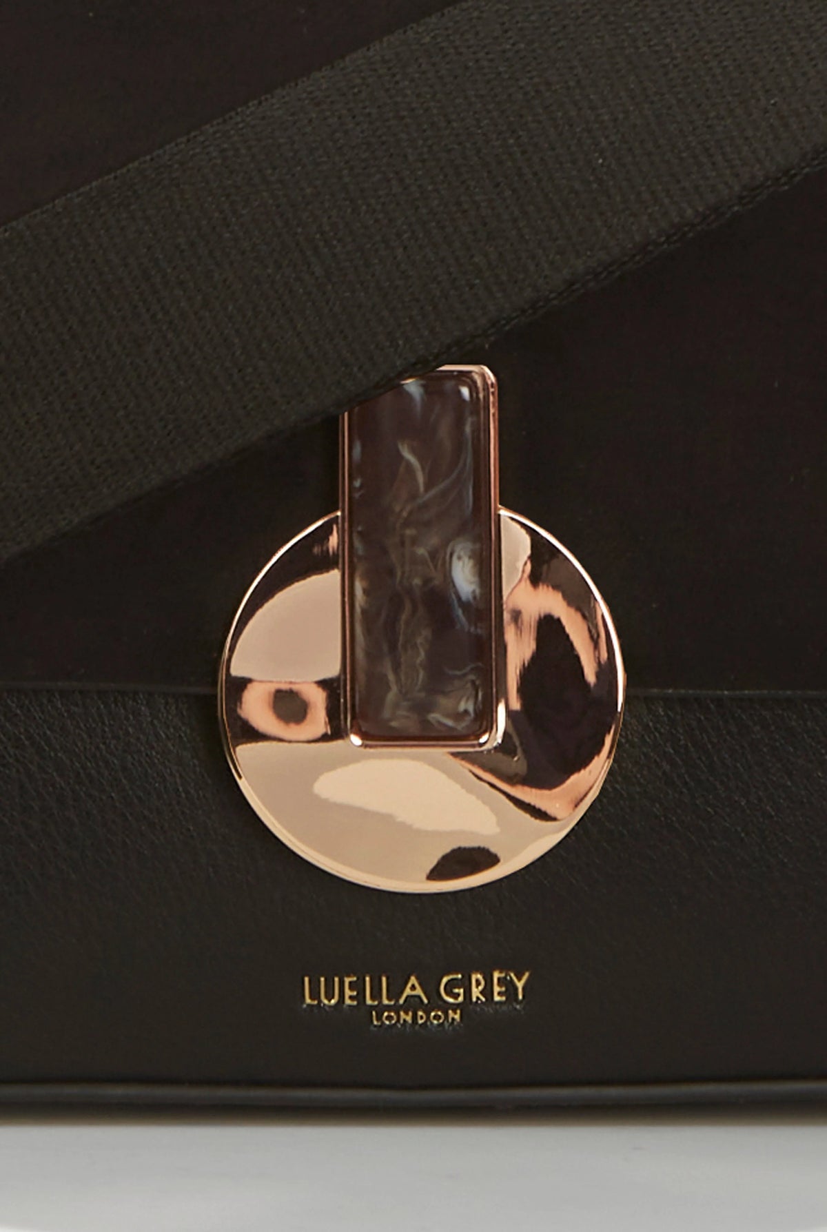 Luella Grey London logo and gold-toned clasp on black bag flap