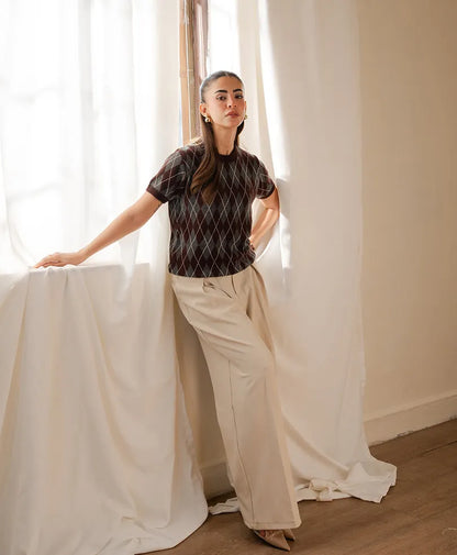 Fitted argyle knit top with short sleeves, dark base and white diamond pattern