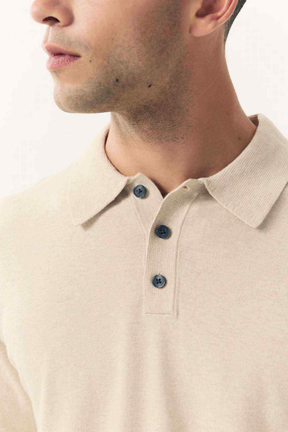 Close-up: men's light beige knit polo collar and three-button placket