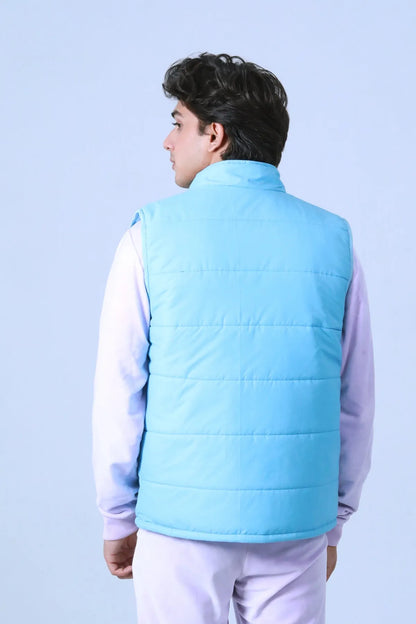Blue quilted puffer vest with hood, back view with horizontal stitching