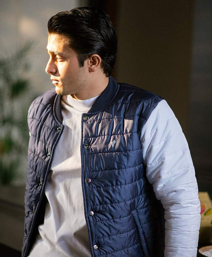 Navy quilted sleeveless vest with button front and high ribbed knit collar