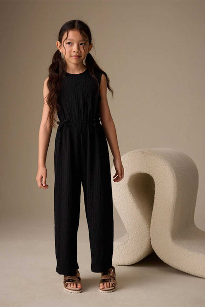 Kids black sleeveless jumpsuit with tie waist and wide legs