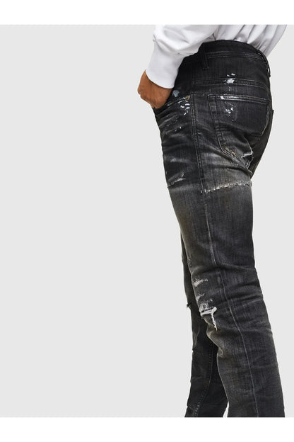 Men’s dark black jeans with side seam fading and distressed marks on leg