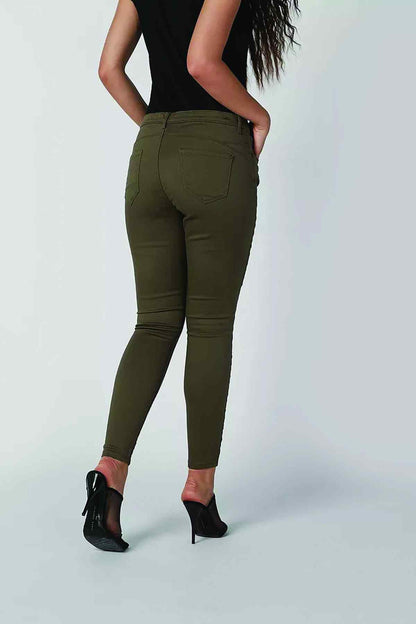 Olive green slim-fit jeans back view with welt pockets and tapered legs