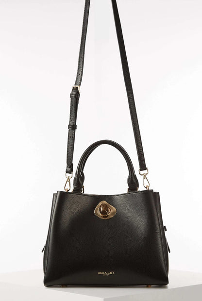 Black handbag with long shoulder straps, top handle, and gold clasp