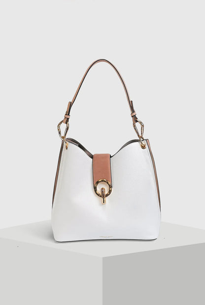 White shoulder bag with brown leather handles and gold ring front clasp