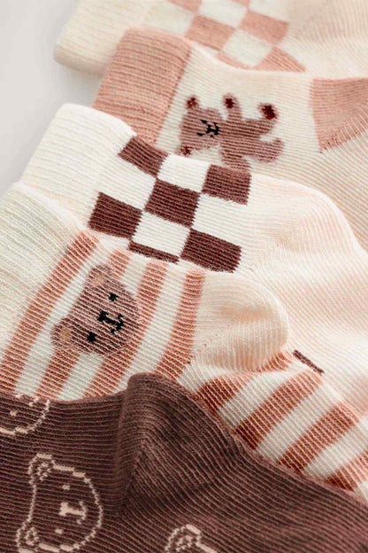 Baby socks close-up in cream and brown with bear and checker pattern
