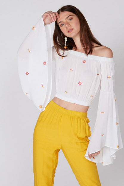 White off-shoulder embroidered crop blouse with long flared sleeves