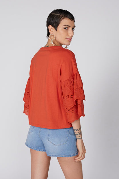 Orange loose-fit blouse, back view, with eyelet lace-trimmed bell sleeves
