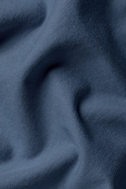 Blue dress shirt fabric close-up with fine textured weave