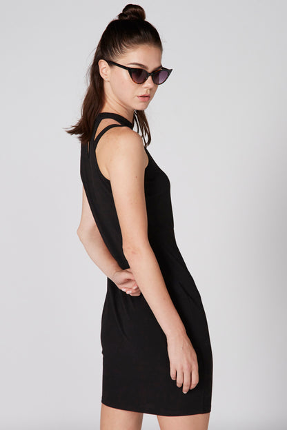 Black fitted sleeveless mini dress with high neckline, side profile