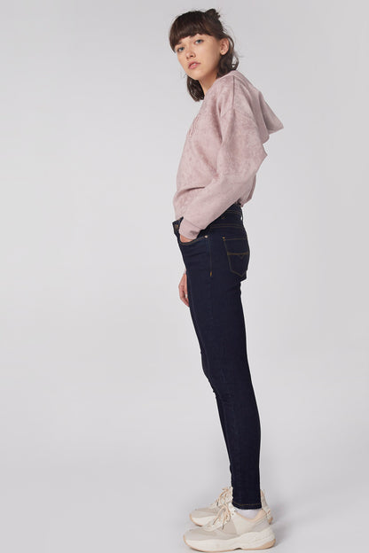 Pink hooded sweatshirt, front graphic visible, paired with dark jeans