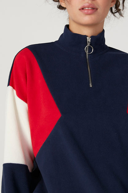 Navy quarter-zip stand collar with metal zipper, red and white shoulder panel