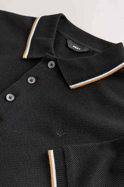 Black polo shirt collar with contrast stripe trim and button placket, close-up