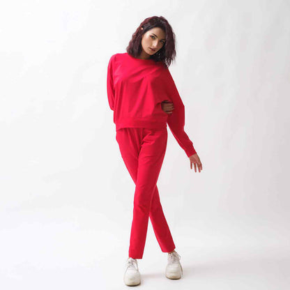 Red tracksuit set with long-sleeve top and tapered jogger pants, side pocket details