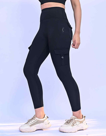 Black ankle-length leggings with side cargo pocket and thigh seam detail.