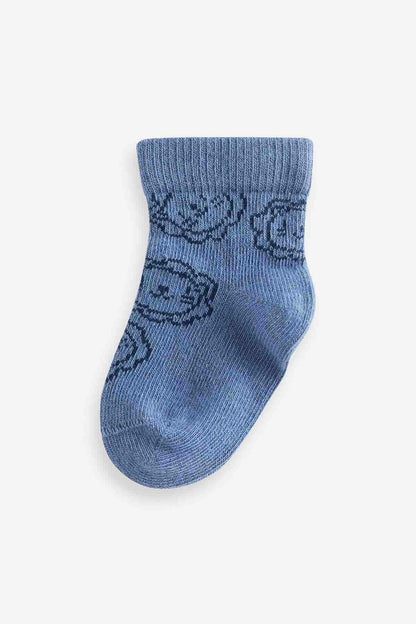 Navy baby sock with allover bear-and-swirl knit pattern
