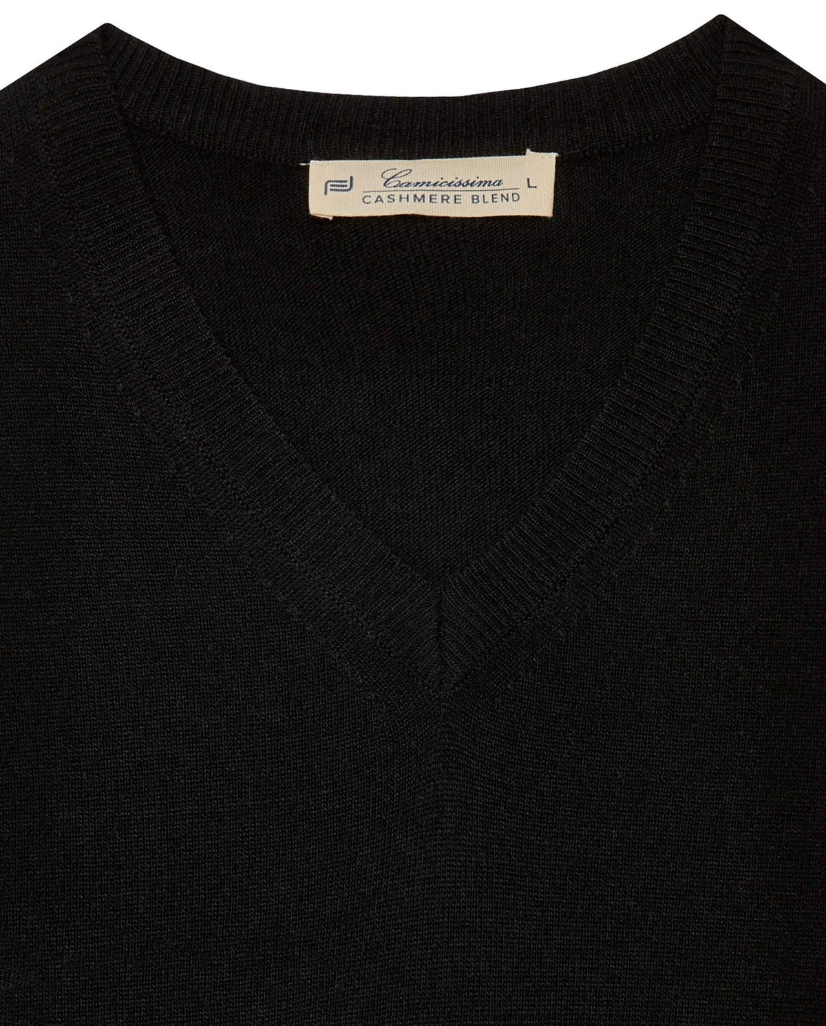 Black V-neck knit sweater close-up, neckline ribbing and care label